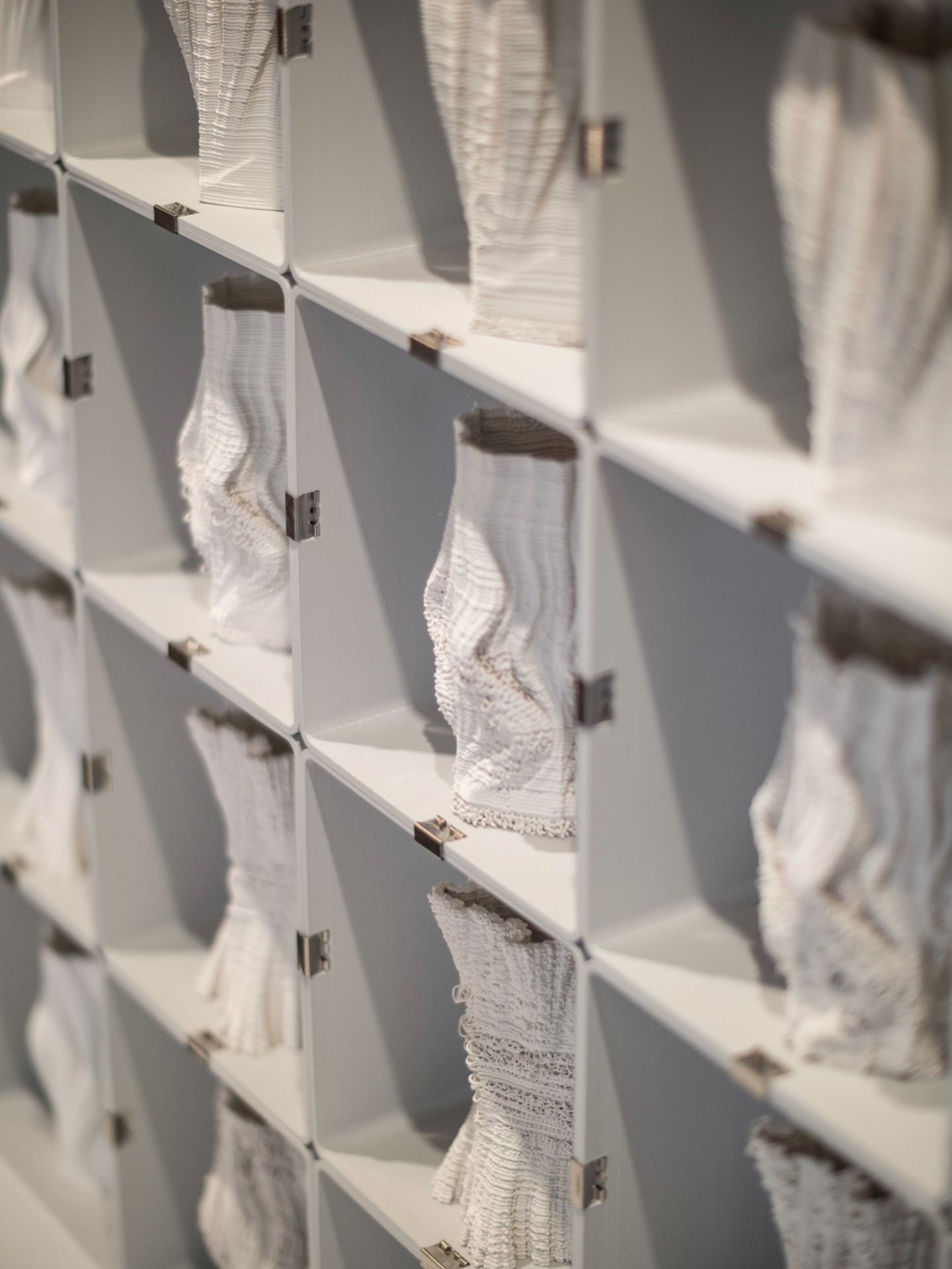 Shelf with 3d printed clay sculptures from the "Desires" exhibition at Form/Design Center. 