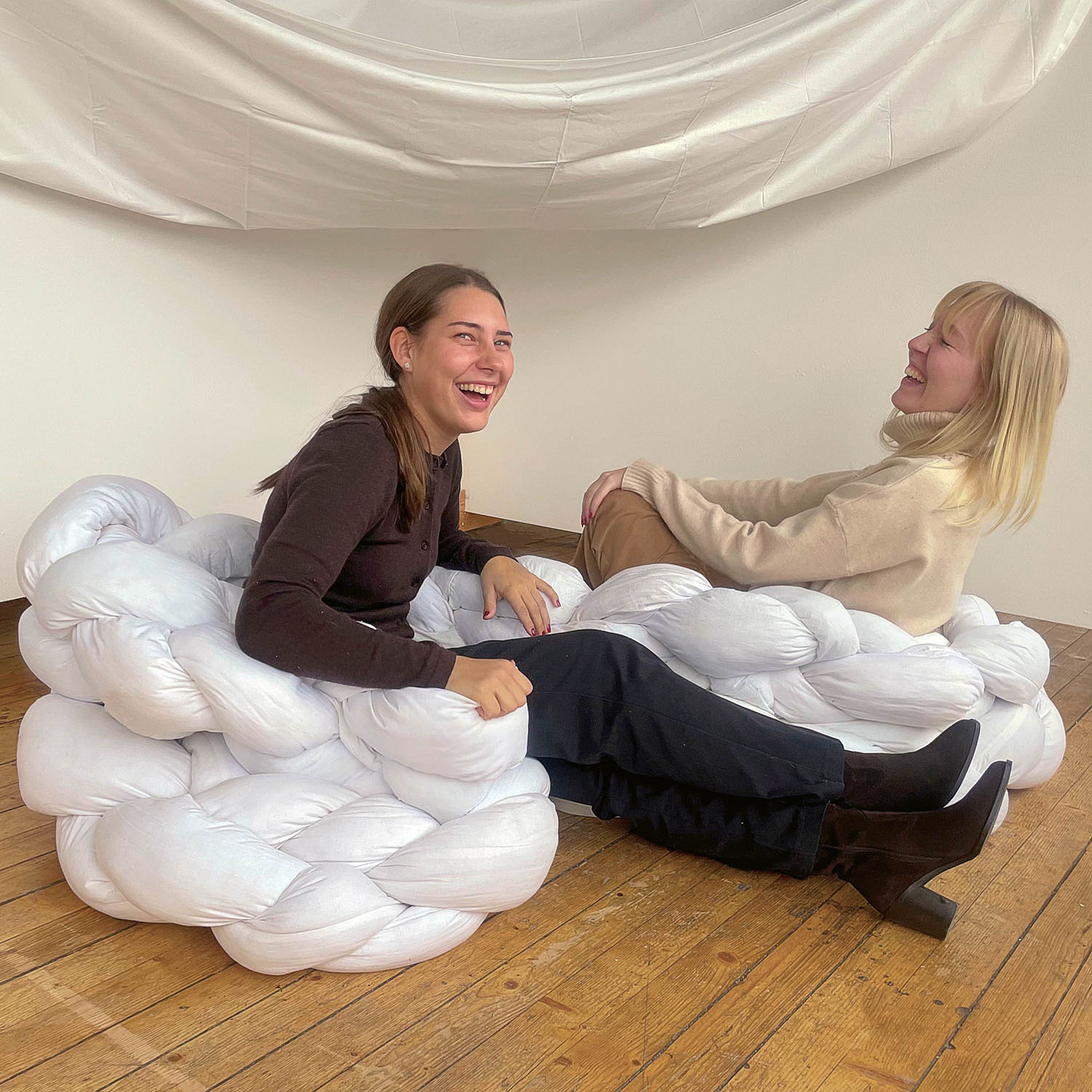 Two women in armchair. Photo.